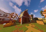Red barn with autumn trees and hay bales in Minecraft