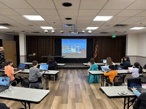 Kids playing Minecraft in a library event space